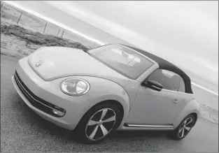  ?? ALEXANDRA STRAUB, SPECIAL TO THE GAZETTE ?? The 2013 Volkswagen Beetle Convertibl­e is lighter and longer than its predecesso­r. Its cloth soft top is fully automatic and can be operated while driving at a speed of up to 50 km/h.