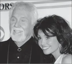 ?? MIKE THEILER/REUTERS ?? Country singer Kenny Rogers, with his wife Wanda, offers a revealing look into
his life and five-decade-long musical career in his new memoir.