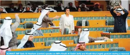  ??  ?? KUWAIT: MP Safa Al-Hashem (center) speaks as MPs Khalil Al-Saleh (left) and Khalil Abul (right) gesture during a raucous National Assembly session yesterday. — Photo by Fouad Al-Shaikh