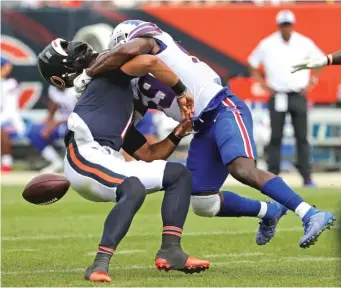  ?? JONATHAN DANIEL/GETTY IMAGES ?? Bills linebacker Andre Smith knocks off Bears quarterbac­k Justin Fields’ helmet with a hard hit on a blitz Saturday. A similar offensive failure occurred last season with Nick Foles at QB.