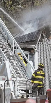  ?? STAFF PHOTOS BY MATT STONE ?? TRAGEDY: East Bridgewate­r firefighte­rs, above and left, hose down a home on Beaver Village Way.