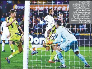  ??  ?? Swansea City goalkeeper Kristoffer Nordfeldt gathers the ball as Notts County striker Jon Stead (left) closes in during yesterday’s English FA Cup 4th round replay at The Liberty Stadium in Wales. Swansea won 6-1. – AFPPIX