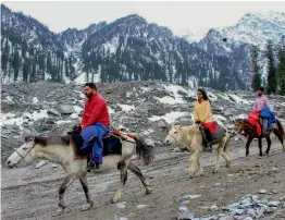  ?? — PTI ?? Tourists ride on horses after snowfall at Anjni Mahadev near Manali on Friday.