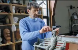  ?? MORGAN KARANASIOS VIA AP ?? In this photo provided by Morgan Karanasios, sculptor Valery Mahuchy works on a clay model for his bronze statue of the comic book character “Archie” at his studio in Bethlehem, N.H.