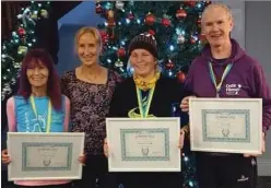  ??  ?? Gerard Fay (right) receives his award for completing his 500th marathon from former Olympian Catherina McKiernan (second left) at a function in Clonakilty.