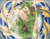  ?? BIBBY GIGNILLIAT ?? Whether you roast the salmon or grill it, these sensationa­l pita sandwiches brim with flavor, thanks to a black olive aioli and fresh cherry tomatoes.