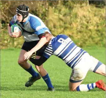  ?? Photo by Domnick Walsh / Eye Focus ?? Tralee’s Ronan O’Sullivan and Martin Houlihan, Dungarvan in action during the game in O’Dowd Park, Tralee