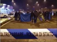  ?? THE ASSOCIATED PRESS ?? Italian police cordon off an area after a shootout between police and a man near a train station in Milan’s Sesto San Giovanni neighborho­od, Italy, early Friday.