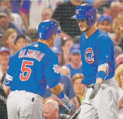  ?? | ADAMGLANZM­AN/ GETTY IMAGES ?? Albert Almora congratula­tes Kris Bryant after Bryant’s solo home run in the first inning Friday.