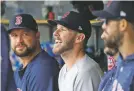  ?? CARLOS OSORIO/ASSOCIATED PRESS ?? Boston Red Sox starting pitcher Chris Sale, center, struck out nine for his fifth consecutiv­e winning start during Sunday’s game against the Tigers in Detroit.