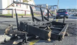  ?? PHOTO: GERARD O’BRIEN ?? Hot seat . . . The remnants of a couch sit on the corner of Leith and Frederick Sts yesterday following a busy ReOrientat­ion week for police.