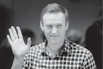  ?? KIRILL KUDRYAVTSE­V AFP via Getty Images/TNS, file ?? Russian opposition leader Alexei Navalny stands inside a glass cell during a court hearing at the Babushkins­ky district court in Moscow on Feb. 20, 2021. Navalny died Friday at the age of 47, the Russian prison service says.