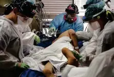  ??  ?? Nurses work to turn a patient over to make breathing easier in the COVID-19 ICU at University Medical Center in Lubbock. The city has administer­ed only about 200 doses of a new antibody medication.