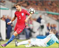  ?? (AP) ?? England’s Kyle Walker (left), is challenged by Slovenia’s Bojan Jokic during the World Cup Group F qualifying soccer match between Slovenia and England at
Stozice Stadium in Ljubljana, Slovenia on Oct 11.