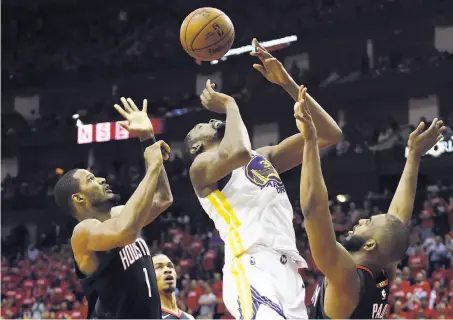  ?? Ronald Martinez / Getty Images ?? The Warriors’ Kevin Durant vies for the ball against Houston’s Trevor Ariza (left) and Chris Paul in the third quarter.