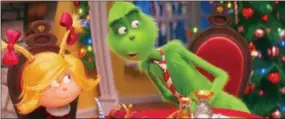  ?? ASSOCIATED PRESS ?? This image released by Universal Pictures shows the characters Cindy-Lou Who, voiced by Cameron Seely, left, and Grinch, voiced by Benedict Cumberbatc­h, in a scene from “The Grinch.”