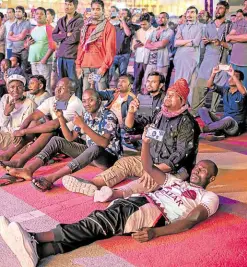  ?? ?? LAID-BACK After toiling to build Qatar’s World Cup facilities, migrant workers are given the treat of watching the game at their leisure.