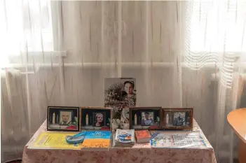  ?? ?? The photograph­s of Valentyna Kozyr’s relatives who were killed by Russian missile attack on a cafe, at Valentyna’s house in the village of Groza, Kharkiv region, amid the Russian invasion of Ukraine.