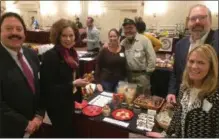  ?? BY PAUL POST ?? State and local officials organized the Food and Farms Business Expo at The Desmond Hotel on Tuesday. From left to right are Warren County Cornell Cooperativ­e Extension Executive Director James Seeley, 109th District Assemblywo­man Pat Fahey, vendors Julie Ryan and Bryan Ducharme of Wild Hill Maple in Salem, state agricultur­e Deputy Commission­er Kevin King and Albany County Cornell Cooperativ­e Extension Executive Director Lisa Godlewski.