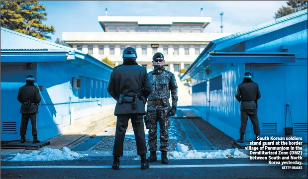  ?? GETTY IMAGES ?? South Korean soldiers stand guard at the border village of Panmunjom in the Demilitari­zed Zone (DMZ) between South and North Korea yesterday.