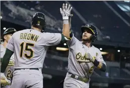  ?? ROSS D. FRANKLIN — THE ASSOCIATED PRESS ?? The A’s Jed Lowrie (8) celebrates his three-run home run against the Diamondbac­ks during the seventh inning on Tuesday in Phoenix.