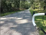  ?? NWA Democrat-Gazette/FLIP PUTTHOFF ?? The tour road at Pea Ridge National Military Park makes for pleasant bike riding through the Civil War battlefiel­d.