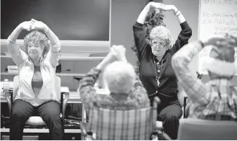  ?? TRIBUNE NEWS SERVICE ?? People with dementia and other illnesses are led through an exercise. Millions of baby boomers are reaching the age of maximum vulnerabil­ity to Alzheimer’s disease and dementia.