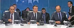  ?? (AFP) ?? President Emmanuel Macron (centre) at a late night emergency meeting in Paris on Tuesday