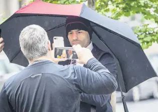  ?? PHOTO: TNS ?? Under scrutiny . . . Lawyer Aaron Schlossber­g, the man who ranted against people speaking Spanish in a New York restaurant, takes a cellphone video of reporters filming him as he leaves his home in Manhattan, New York, last month.