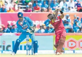  ?? RANDY BROOKS/AFP/GETTY IMAGES ?? Dwayne Bravo, right, of West Indies bowled by Amit Mishra of India during the second and final T20i between West Indies and India at Central Broward Stadium on Sunday.