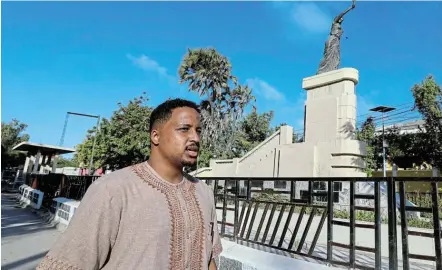  ?? Picture: REUTERS / FEISAL OMAR ?? TIME TO PLAN: Somali-Italian architect Omar Degan walks past the statue of Hawo Tako, in Mogadishu, Somalia, while thinking of how the city could change.