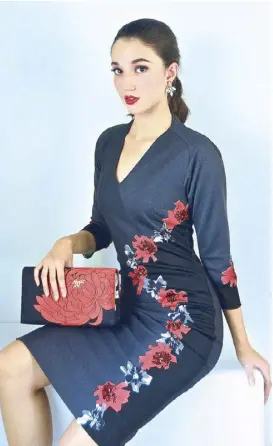  ?? Photograph­y by JOANNE ZAPANTA-ANDRADA • Makeup, hairstylin­g and bags by REY LEGARDA • Model: KATHARINE SANTIAGO KERR ?? Black stretch V-neck, 3/4-sleeved dress with red and silver floral appliqué by Chito De Los Santos.