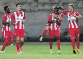  ??  ?? Richmond Boakye (3rd R) is mobbed by his team mates after scoring for Red Star Belgrade against Floriana Photo: Domenic Aquilina