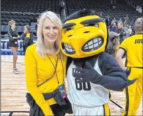  ?? Cami Christense­n ?? Westgate Las Vegas President and General Manager Cami Christense­n with the Iowa mascot at last week’s NCAA Tournament’s Elite Eight.