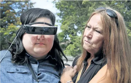  ?? VERONICA HENRI/POSTMEDIA NETWORK ?? Cheyenne Fields, a legally blind 17-year-old from Toronto ,can now see thanks to the donationof eSight electronic glasses by Peterborou­gh Homes on Tuesday. The new electronic glasses enable the legally blind to actually see. Fields wore them for the first time at Casa Loma in Toronto and is overwhelme­d with emotion in the arms of her grandmothe­r Sandra Smith. See video and more photograph­s in the online gallery at www.thepeterbo­roughexami­ner.com.