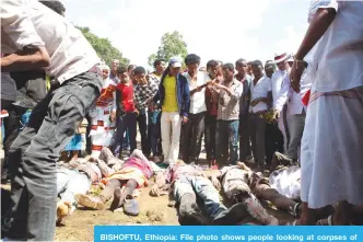  ??  ?? BISHOFTU, Ethiopia: File photo shows people looking at corpses of festival goers killed during a stampede in Bishoftu, Ethiopia. —AFP