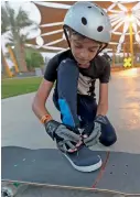  ??  ?? GETTING READY TO GO... A kid secures his shoelace before beginning to skate at the XDubai Skatepark.