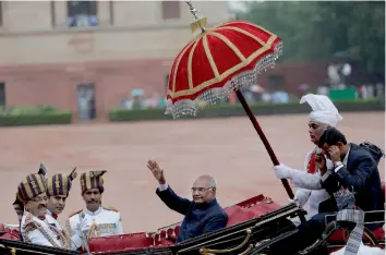  ?? — AP ?? President Ram Nath Kovind waves as he arrives in a traditiona­l horse-driven carriage at the Rashtrapat­i Bhavan in New Delhi on Tuesday after being sworn in.