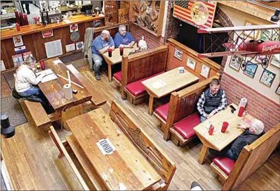  ?? PHOTOS BY GILLIAN FLACCUS / AP ?? Diners sit at the Carver Hangar, a restaurant in Boring, Ore., on Jan. 6. As coronaviru­s deaths soar, a growing number of restaurant­s like Carver Hangar in states across the country are reopening in defiance of strict COVID-19 rules that have shut them down for indoor dining for weeks, or even months.