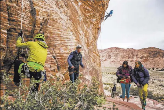  ?? Patrick Connolly Las Vegas Review-Journal @PConnPie ?? Profession­al photograph­er John Evans, second from left, teaches a climbing photograph­y clinic as climbers Gorge Bieker of Arkansas, left, and Greg Tambornino of Minneapoli­s, third from left, climb their routes at Calico Basin.