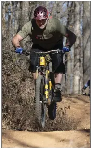  ?? (NWA Democrat-Gazette/Spencer Tirey) ?? Rusty Cramer rides on Coler Preserve in Bentonvill­e last month with other Team Low-T riders. Cramer, 50, is the youngest in the group.