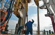  ?? Eddie Seal / Bloomberg ?? A crew works on a drilling rig in Webb County. Two recent reports point to an improved oil patch outlook.