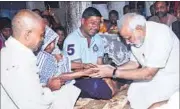  ?? PTI PHOTO ?? Narendra Modi consoles the family members of Rajnarain Singh, a victim of the Patna serial blasts, on Saturday.