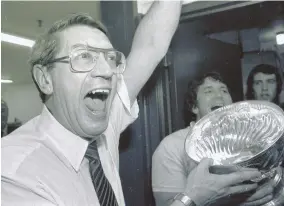  ?? AP FILE PHOTO ?? HOCKEY LEGEND: New York Islanders coach Al Arbour celebrates in the locker room as he holds the Stanley Cup after the Islanders won their fourth title in a row in 1983. Arbour died Friday at 82.