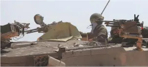  ?? (Amir Cohen/Reuters) ?? IDF SOLDIERS take part in a tank maneuver near the border with Gaza, last week. Victory cannot be only military, it must also political and diplomatic, the writer argues.