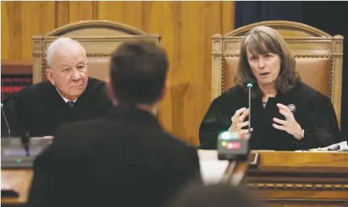  ?? LUIS SÁNCHEZ SATURNO/THE NEW MEXICAN ?? New Mexico Supreme Court Justice Michael E. Vigil and Chief Justice C. Shannon Bacon question Holly Agajanian, the governor’s chief general counsel, while she argues at the court Monday morning. The National Rifle Associatio­n and Republican state lawmakers filed a petition with the court in response to Gov. Michelle Lujan Grisham’s suspension of the right to carry open or concealed firearms in public places in Albuquerqu­e and Bernalillo County.