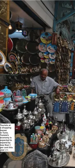  ?? EPA ?? Tourists at a shopping bazaar in Tunis. Tunisia’s economy is expected to expand by less than 1 per cent this year