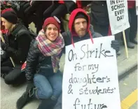  ?? MITCH DUDEK/SUN-TIMES ?? LEFT: Westinghou­se history teachers Linda Becker and Luke Staszak attend the rally Wednesday outside City Hall.