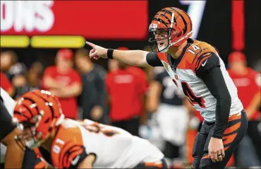  ?? GETTY IMAGES ?? Bengals quarterbac­k Andy Dalton makes a call at the line during the second quarter against the Falcons. Dolphins coach Adam Gase enjoys watching Dalton connect with A.J. Green “when you’re not playing them.”