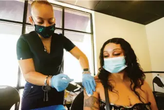  ?? Rogelio V. Solis / Associated Press ?? Nurse Tameiki Lee vaccinates Betty White for COVID-19 on July 19 at an inoculatio­n station in Jackson, Miss. Updated versions of vaccine formulas are expected to be available this fall.